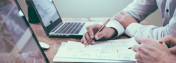 man with pencil and laptop